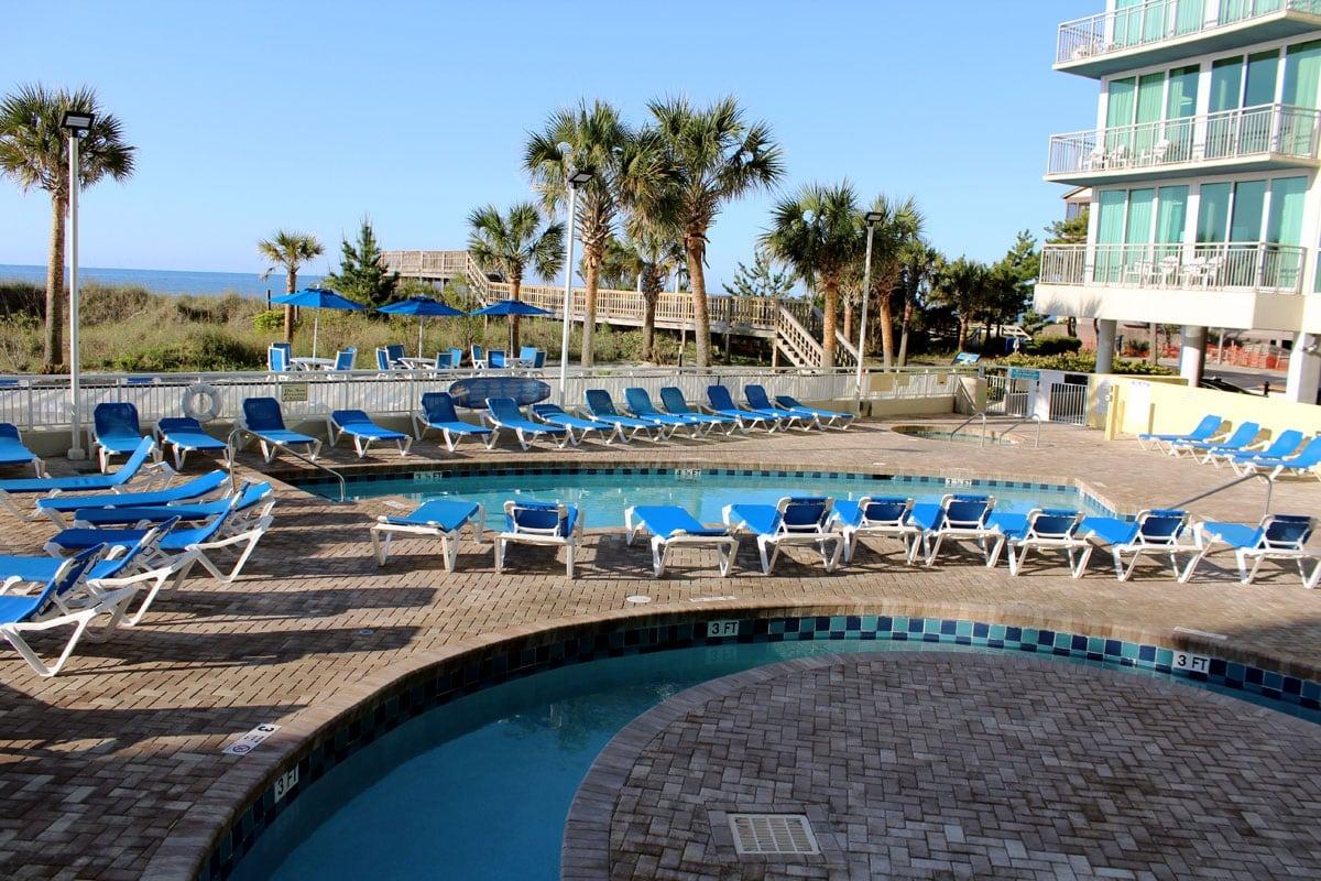 The Lazy River of the Avista Resort with pool chairs surrounding the river