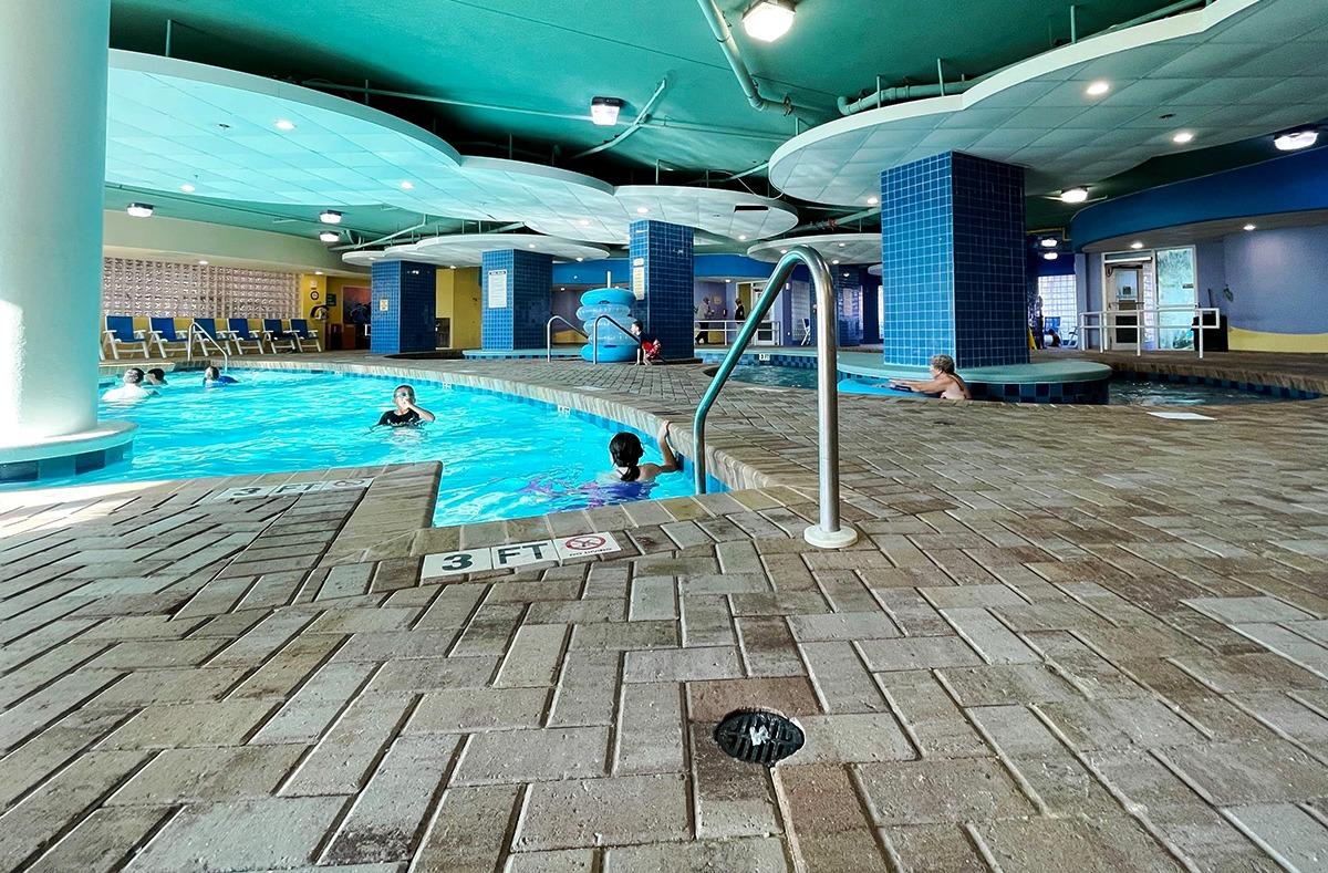 Guests enjoying the indoor pool and indoor section of the Lazy River of the Avista Resort
