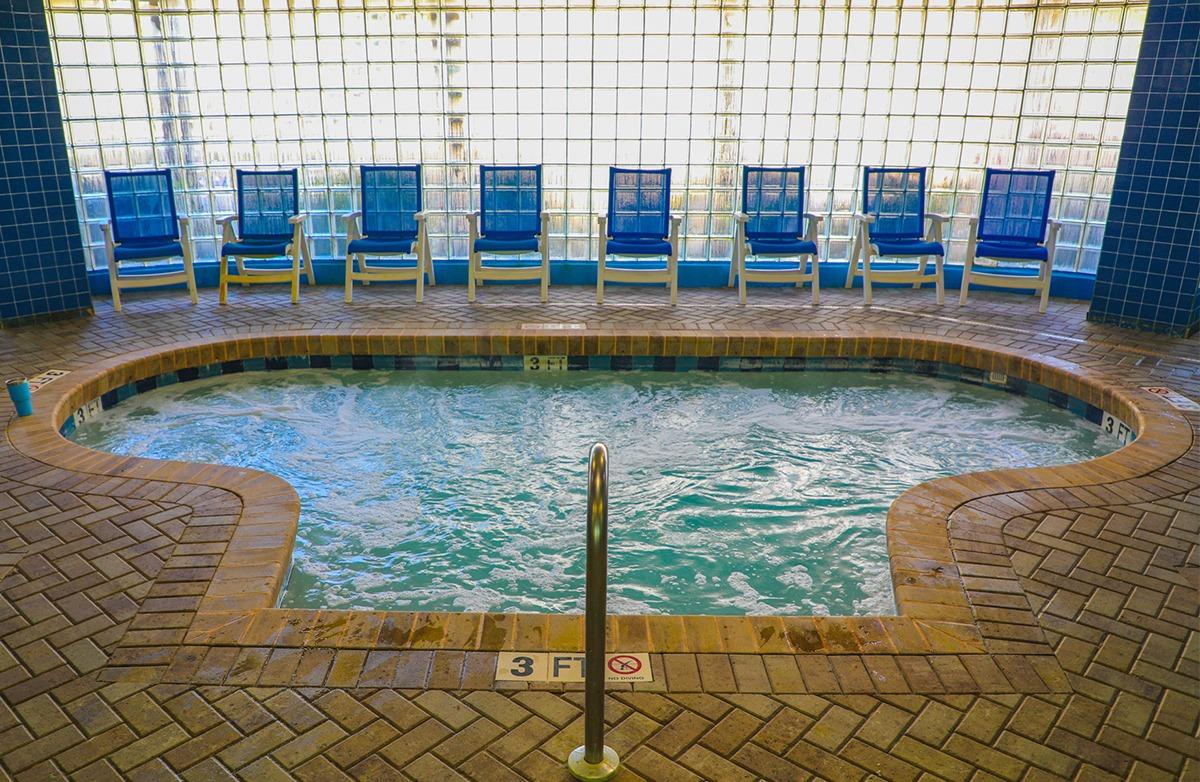 Indoor hot tub at the Avista Resort surrounded by blue pool chairs