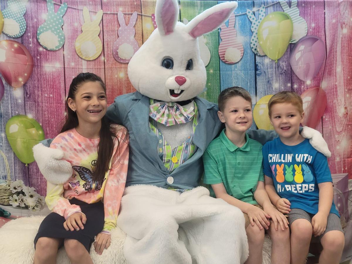 The Easter bunny hugging kids on Easter near the Avista Resort