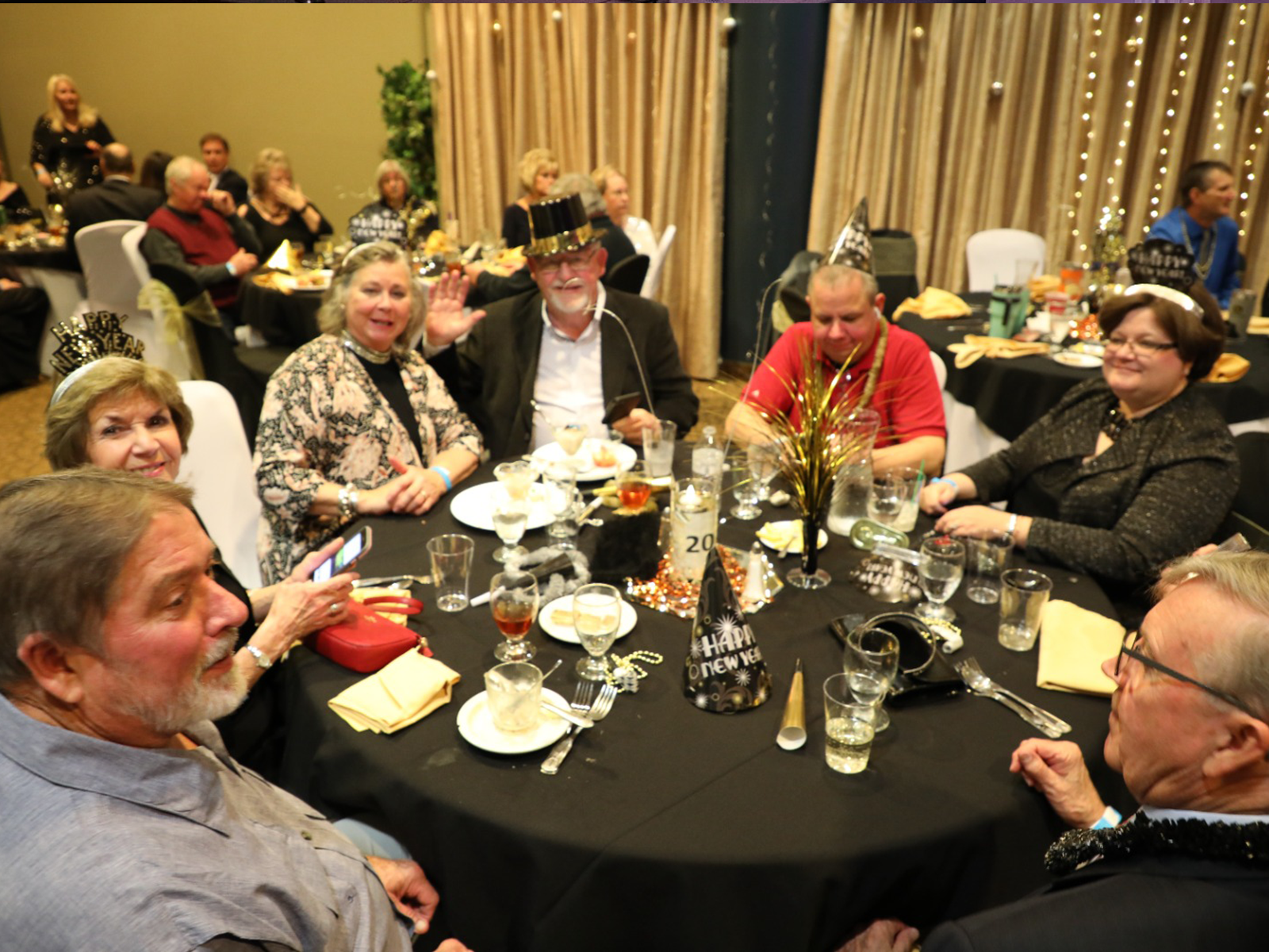 Happy dinner guests at the Avista Resort sitting around a table.