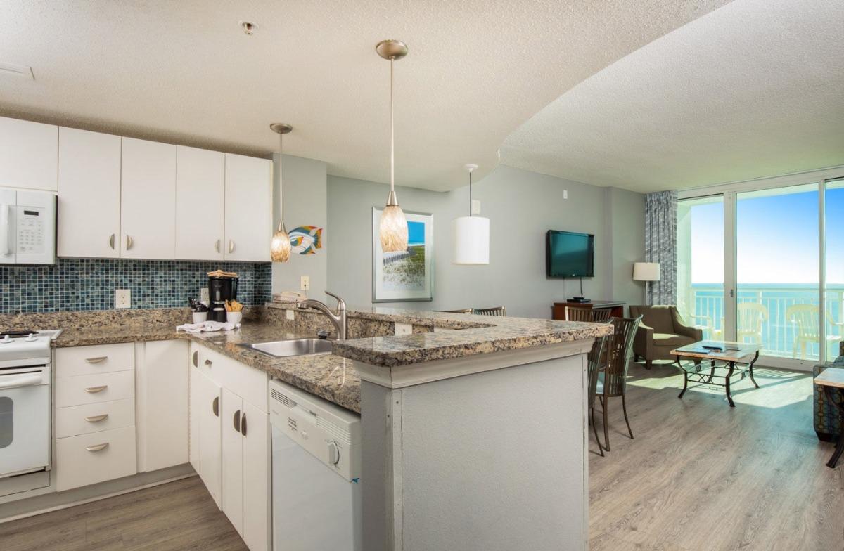 a 2-bedroom oceanfront condo room type E1 at Avista Resort of the living and kitchen