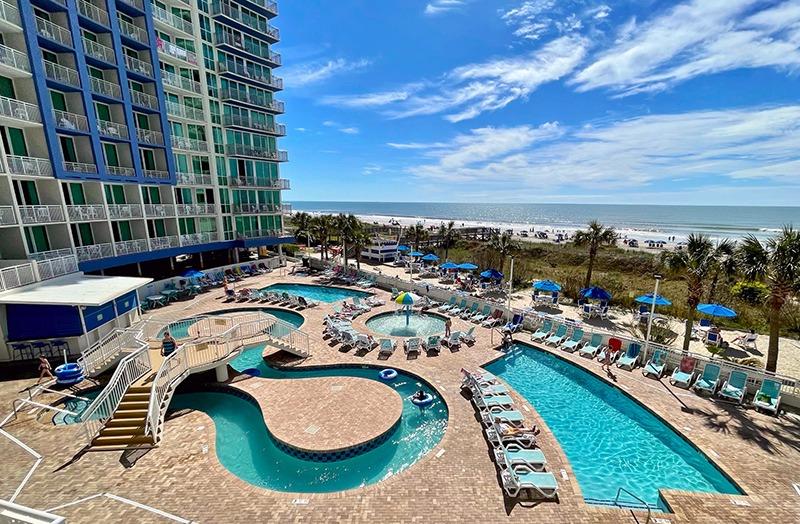 Overview of outdoor swimming pool and lazy river at Avista Resort