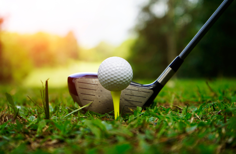 Golf Club and golf ball on a grassy lawn