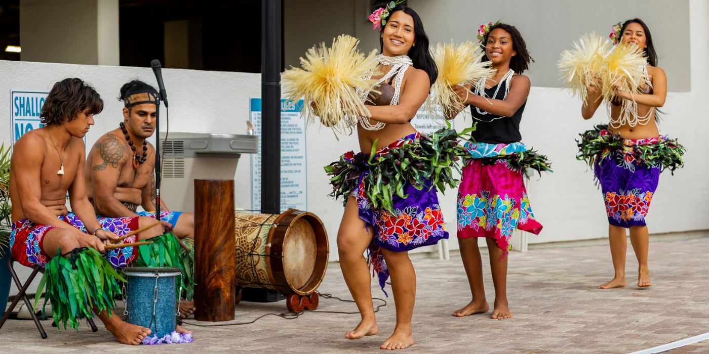 Image of three hula dancers performing at the Avista Resort pool deck