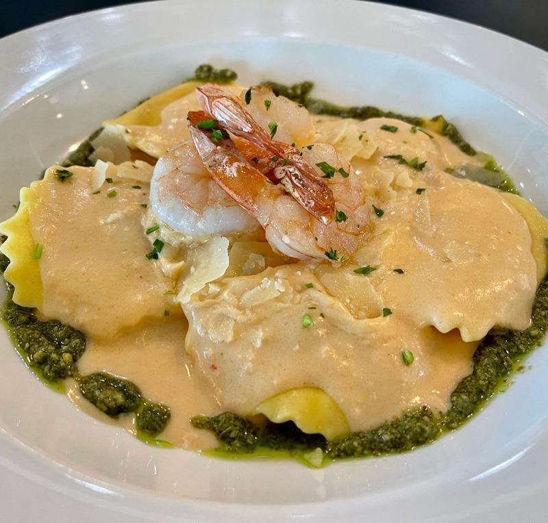 Lobster ravioli in a cream sauce with pesto and shrimp