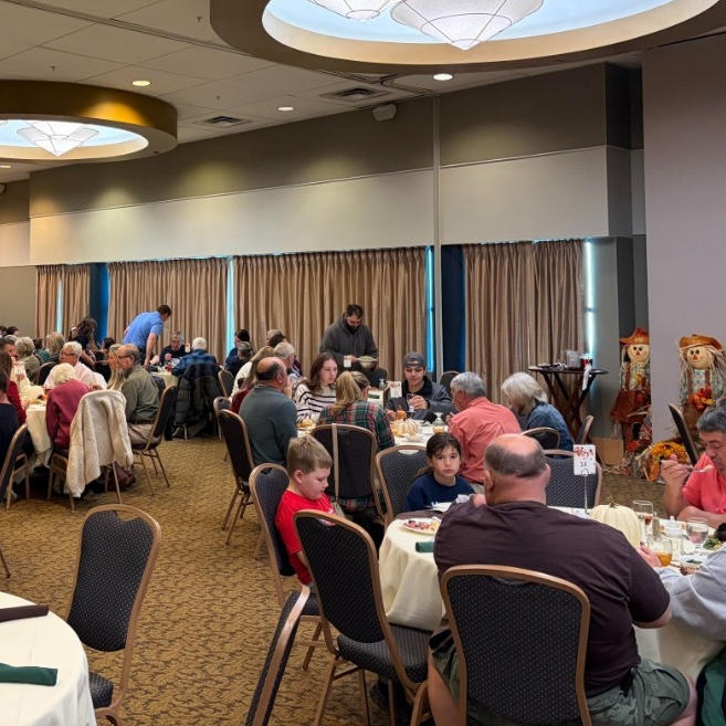 Wooden sign in the shape of a pumpkin that says welcome