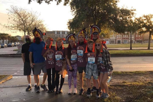 Group in turkey hats ready for a Thanksgiving-themed run at dawn.