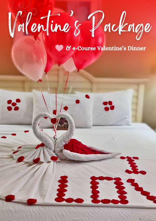 Group of smiling people wearing hawaiian leis at an outdoor table